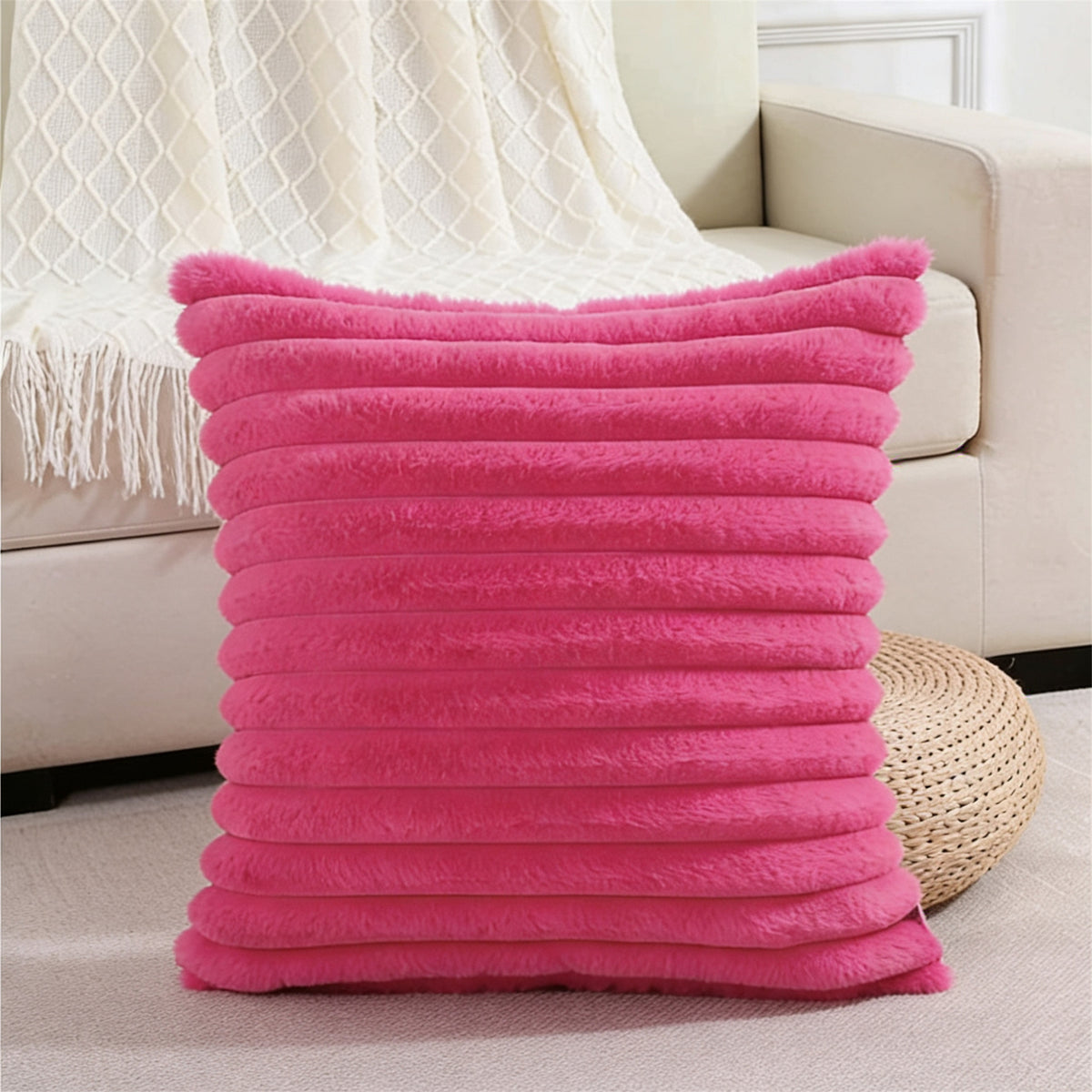 Verdelisse faux fur throw pillow cover in Hot Pink on a sofa with a white knit throw