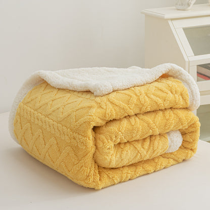 Verdelisse Double-Sided Sherpa Blanket in Yellow, folded to show the knit side and white sherpa lining