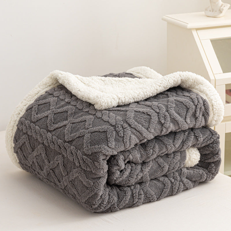 Verdelisse Double-Sided Sherpa Blanket in Gray, folded to show the knit side and white sherpa lining
