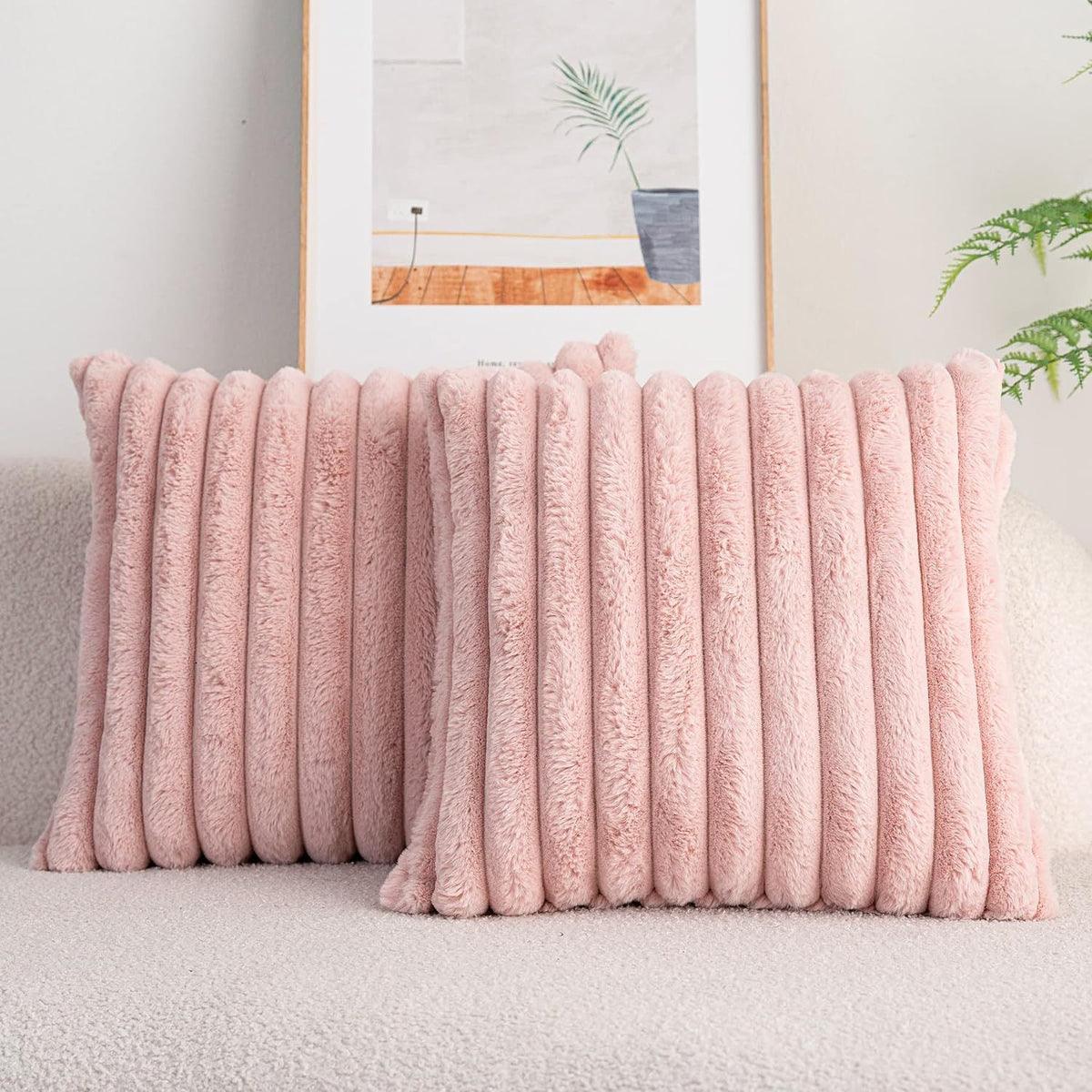 Verdelisse faux fur throw pillow covers in Pink, a pair on a light sofa