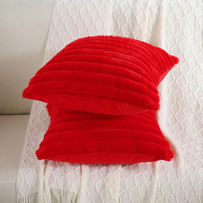 Verdelisse faux fur throw pillow covers in Red, two covers stacked on a white knit throw