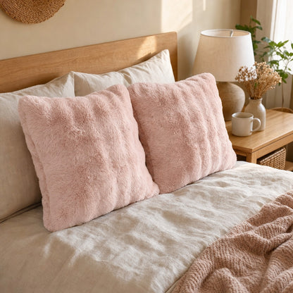 Verdelisse Faux Fur Throw Pillow Cover in Pink on a made bed