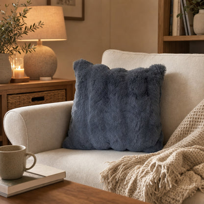 Verdelisse Faux Fur Throw Pillow Cover in Dark Gray on a cream armchair