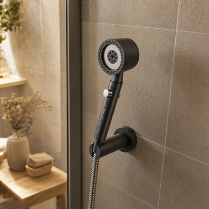 Verdelisse Pressure-Boosting Handheld Shower in Grey, resting in a wall holder in a tiled shower