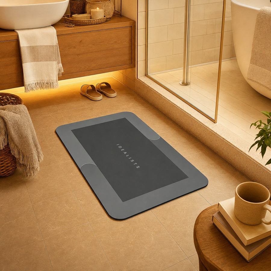 Quick Dry Bath Mat in Dark Grey on a warm bathroom floor in front of the shower