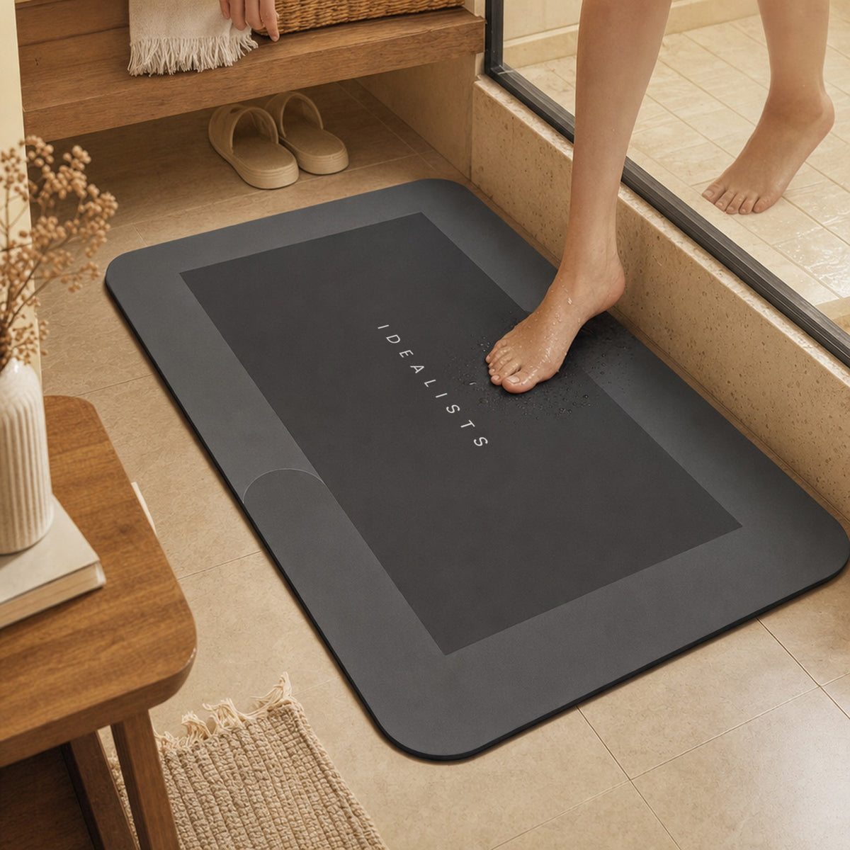 Wet foot stepping onto the Quick Dry Bath Mat in Dark Grey after a shower