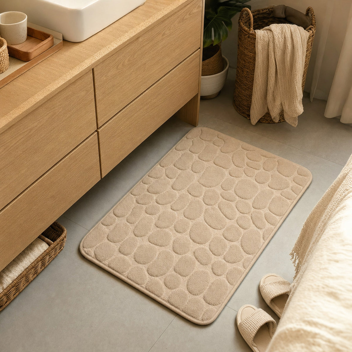 Verdelisse Stone Bath Mat in Camel in front of a wooden bathroom vanity