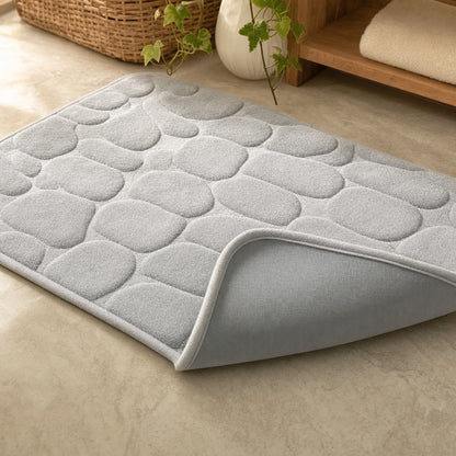 Verdelisse Stone Bath Mat in Light Grey, corner flipped up to show the PVC anti-slip backing
