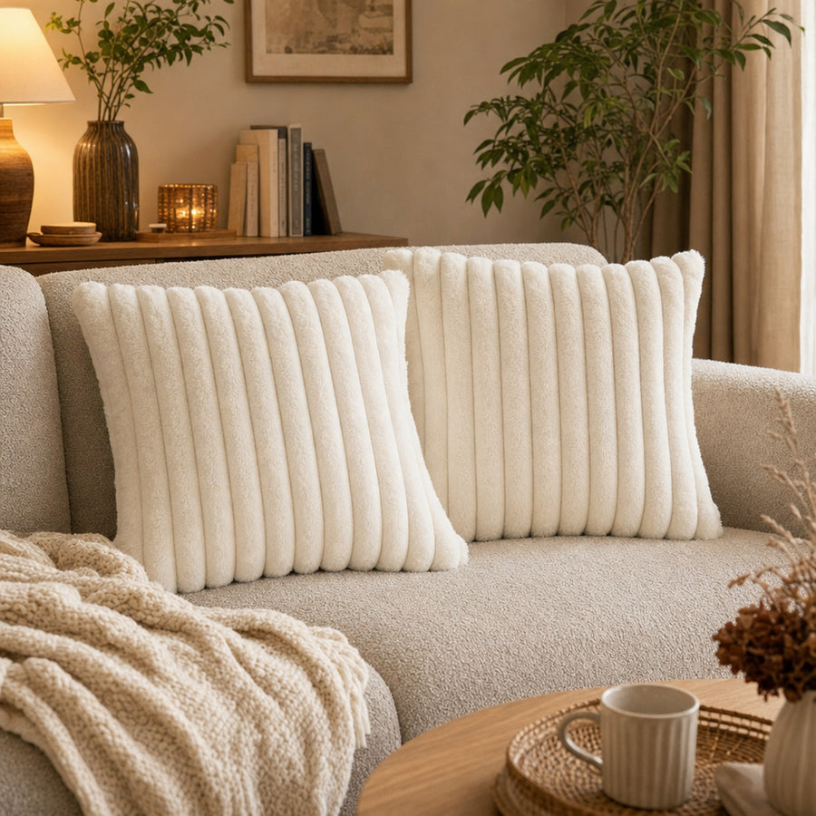 Verdelisse faux fur throw pillow covers in Cream White, a pair on a cozy boucle sofa