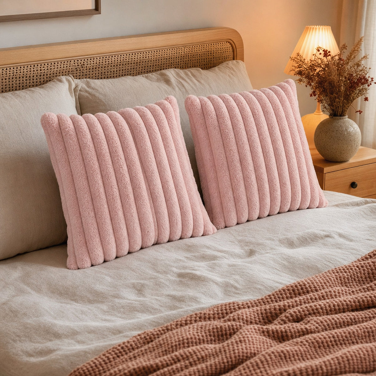 Verdelisse faux fur throw pillow covers in Pink on a made bed
