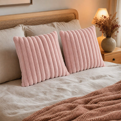 Verdelisse faux fur throw pillow covers in Pink on a made bed