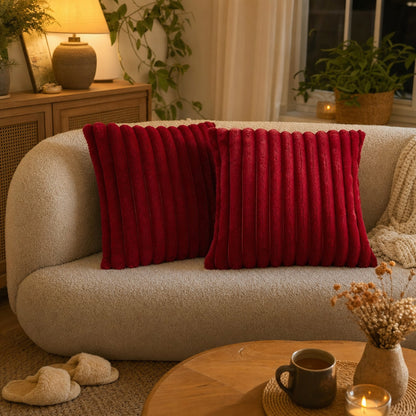 Verdelisse faux fur throw pillow covers in Bordeaux on a rounded sofa in a cozy living room