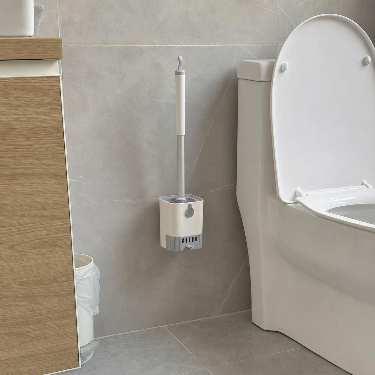 Verdelisse toilet brush kit in white mounted on the wall beside the toilet in an everyday bathroom