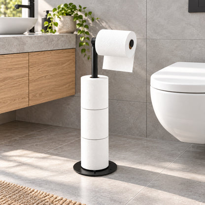 Verdelisse freestanding toilet paper holder in matte black, with one roll and three spare rolls, in a modern grey-tiled bathroom