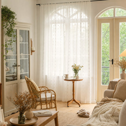 Verdelisse White Sheer Curtain in front of arched windows in a sunny living room